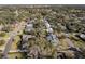 Wide aerial view of neighborhood with mature trees and homes at 825 E Mann Rd, Bartow, FL 33830