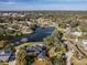 Aerial view of lakefront home with large yard and pool at 825 E Mann Rd, Bartow, FL 33830