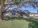 Large backyard with mature oak tree and a swing hanging from it at 825 E Mann Rd, Bartow, FL 33830