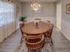 Formal dining room with wood table, chandelier, and neutral decor at 825 E Mann Rd, Bartow, FL 33830