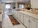 Bright kitchen boasts white cabinets and spacious countertops at 825 E Mann Rd, Bartow, FL 33830