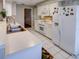 White kitchen with ample counter space and stainless steel sink at 825 E Mann Rd, Bartow, FL 33830