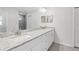 Bathroom with double sinks, granite counters, white cabinets and tile flooring at 9419 Se 163Rd St, Summerfield, FL 34491