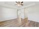 Spacious bedroom features a tray ceiling, ceiling fan and wood-look flooring at 9419 Se 163Rd St, Summerfield, FL 34491