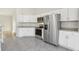 Modern kitchen with stainless steel appliances and white cabinets at 9419 Se 163Rd St, Summerfield, FL 34491