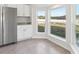 Bright kitchen nook featuring stainless steel refrigerator and plenty of natural light at 9419 Se 163Rd St, Summerfield, FL 34491