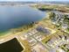 An aerial view of a community showcasing a large lakefront and newly built homes at 951 Craftsman Rd, Eagle Lake, FL 33839