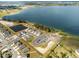 An aerial view of a community showcasing a large lakefront and newly built homes at 951 Craftsman Rd, Eagle Lake, FL 33839