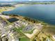 Aerial view of houses and community near a lake at 951 Craftsman Rd, Eagle Lake, FL 33839