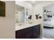 Modern bathroom with double vanity and dark cabinets at 951 Craftsman Rd, Eagle Lake, FL 33839