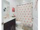 Clean bathroom with shower/tub combo and flamingo decor at 951 Craftsman Rd, Eagle Lake, FL 33839