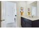 Modern bathroom featuring a vanity with dark cabinets, a large mirror, and modern fixtures at 951 Craftsman Rd, Eagle Lake, FL 33839