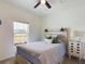 Bedroom with light wood platform bed, ceiling fan, and window at 951 Craftsman Rd, Eagle Lake, FL 33839