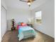 Cozy bedroom featuring carpeted floors, a ceiling fan with light, and a window offering plenty of natural light at 951 Craftsman Rd, Eagle Lake, FL 33839