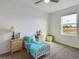 Bright bedroom featuring a ceiling fan, a window for natural light, and carpeted floors, creating a cozy space at 951 Craftsman Rd, Eagle Lake, FL 33839