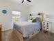 Bedroom with light wood platform bed, ceiling fan, and window at 951 Craftsman Rd, Eagle Lake, FL 33839