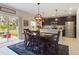 Bright dining area adjacent to the kitchen with an elegant table, chandelier, and sliding door to the outdoor space at 951 Craftsman Rd, Eagle Lake, FL 33839