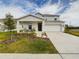 Two-story house with a front porch, two-car garage, and landscaping at 951 Craftsman Rd, Eagle Lake, FL 33839