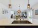 Kitchen island with sink, looking toward dining and living area at 951 Craftsman Rd, Eagle Lake, FL 33839