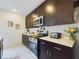 Well-equipped kitchen featuring stainless steel appliances, white countertops, and sleek dark cabinetry at 951 Craftsman Rd, Eagle Lake, FL 33839