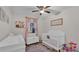 Charming Bedroom with a crib, changing table, and soft decor at 9585 Shreck Rd, Bartow, FL 33830