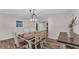 Bright dining room with a farmhouse table and chandelier at 9585 Shreck Rd, Bartow, FL 33830