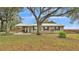 Newly renovated ranch home with metal roof and large oak trees at 9585 Shreck Rd, Bartow, FL 33830