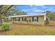 Newly renovated ranch home with metal roof and large oak trees at 9585 Shreck Rd, Bartow, FL 33830