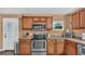 Kitchen with stainless steel appliances and wood cabinets at 9585 Shreck Rd, Bartow, FL 33830