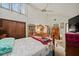 Bedroom with wooden dresser, book shelf and a queen-size bed at 1005 Shadow Run Dr, Lakeland, FL 33813