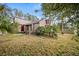 Two-story home with a red door and landscaping at 1005 Shadow Run Dr, Lakeland, FL 33813