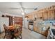 Kitchen with wood cabinets, white appliances and an eat-in area at 1005 Shadow Run Dr, Lakeland, FL 33813