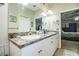 Double vanity bathroom with a large mirror and a tub at 1012 Robin Ln, Winter Haven, FL 33884