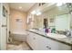 Double vanity bathroom with a large mirror and a tub at 1012 Robin Ln, Winter Haven, FL 33884