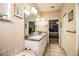 Double vanity bathroom with a large mirror and a tub at 1012 Robin Ln, Winter Haven, FL 33884