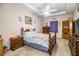 Spacious bedroom with wooden furniture and a ceiling fan at 1012 Robin Ln, Winter Haven, FL 33884