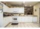 Functional kitchen with white cabinets, tile floors, and stainless steel appliances at 1012 Robin Ln, Winter Haven, FL 33884