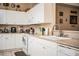 Kitchen with white cabinets, tile flooring, and stainless steel sink at 1012 Robin Ln, Winter Haven, FL 33884