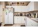 Bright kitchen featuring white cabinets, tile flooring, and ample counter space at 1012 Robin Ln, Winter Haven, FL 33884