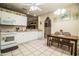 Bright kitchen with white cabinets, ample counter space, and a dining area at 1012 Robin Ln, Winter Haven, FL 33884