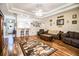 Living room featuring hardwood floors, a wooden cabinet, and comfortable seating at 1012 Robin Ln, Winter Haven, FL 33884