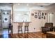 Living room with hardwood floors and a view into the kitchen at 1012 Robin Ln, Winter Haven, FL 33884