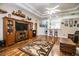 Bright living room with hardwood floors, built-in entertainment center, and ample natural light at 1012 Robin Ln, Winter Haven, FL 33884