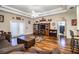 Living room with hardwood floors, a TV stand, and french doors at 1012 Robin Ln, Winter Haven, FL 33884