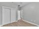 Bedroom with grey walls, wood-look flooring, and sliding closet doors at 1033 Fleming Ave, Lakeland, FL 33815