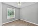 Bright bedroom with grey walls, wood-look flooring, and a window at 1033 Fleming Ave, Lakeland, FL 33815