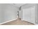 Spacious bedroom with grey walls, wood-look flooring, and double doors at 1033 Fleming Ave, Lakeland, FL 33815