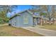 Newly built home with light blue exterior and a spacious front yard at 1033 Fleming Ave, Lakeland, FL 33815