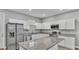 Modern kitchen with white cabinets, granite countertops, and stainless steel appliances at 1033 Fleming Ave, Lakeland, FL 33815