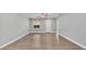 Spacious living room with light grey walls, wood-look floors, and a ceiling fan at 1033 Fleming Ave, Lakeland, FL 33815